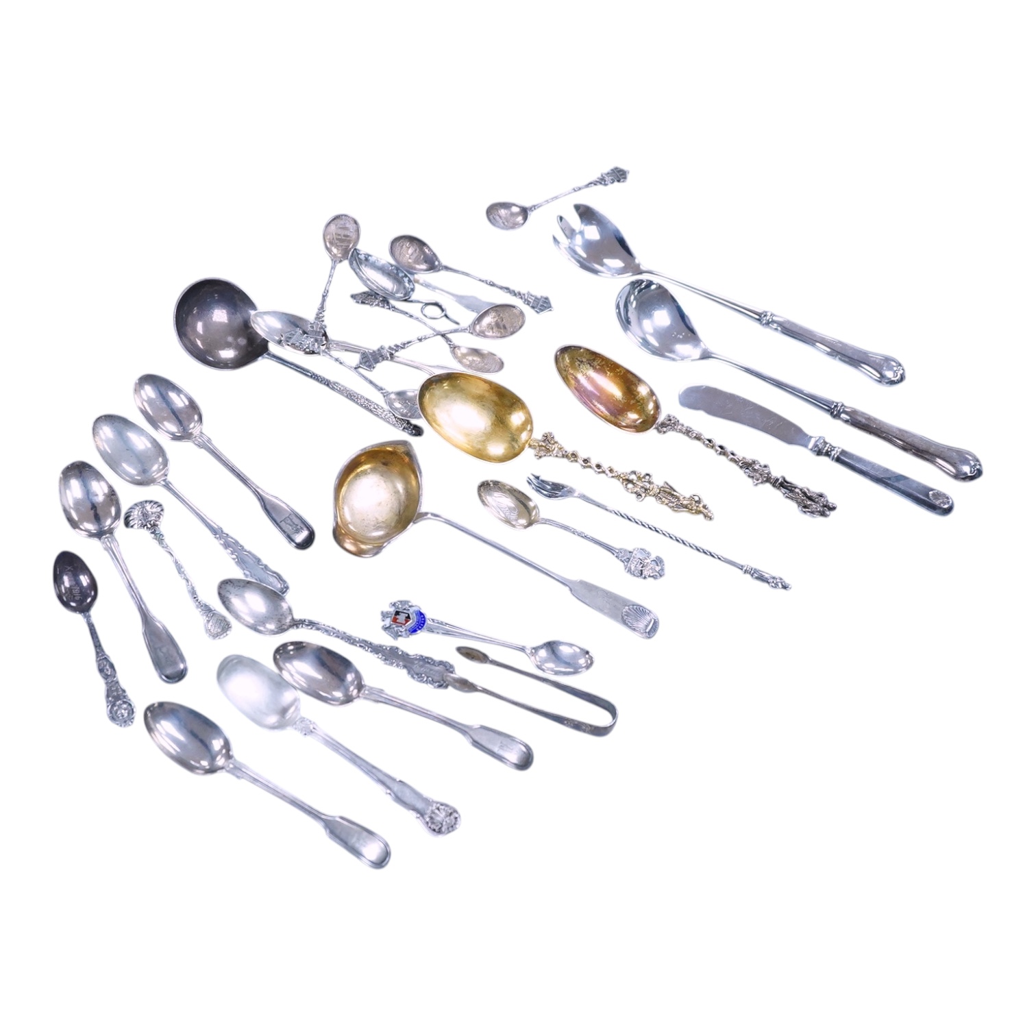 A small quantity of assorted 19th century and later silver and white metal flatware, including teaspoons, commemorative spoons, ladles, sugar tongs, pickle fork, a pair of Swedish salad serves, a similar butter knife and